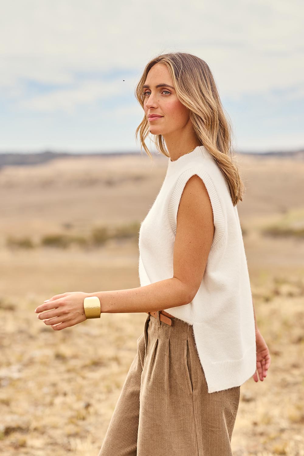 Model Tegan wearing size S of the Found My Friend Recycled Knit Vest in colour Snow (White), from the front, showing the whole outfit