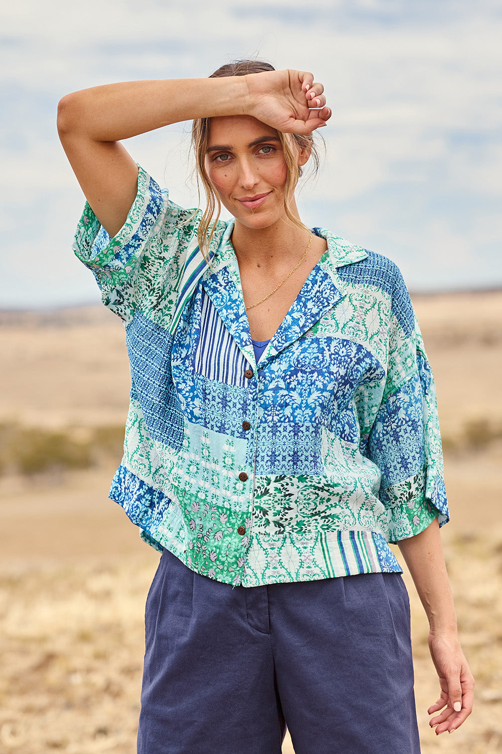 Model Tegan wearing size 10 of the Happy Daze Shirt in colour Greenpatch (Green), from the front, cropped image