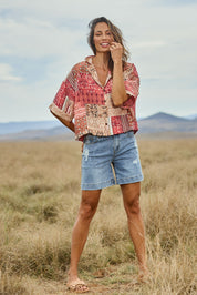 Model Amanda wearing size 10 of the Happy Daze Shirt in colour Patch (Pink), from the front, showing the whole outfit