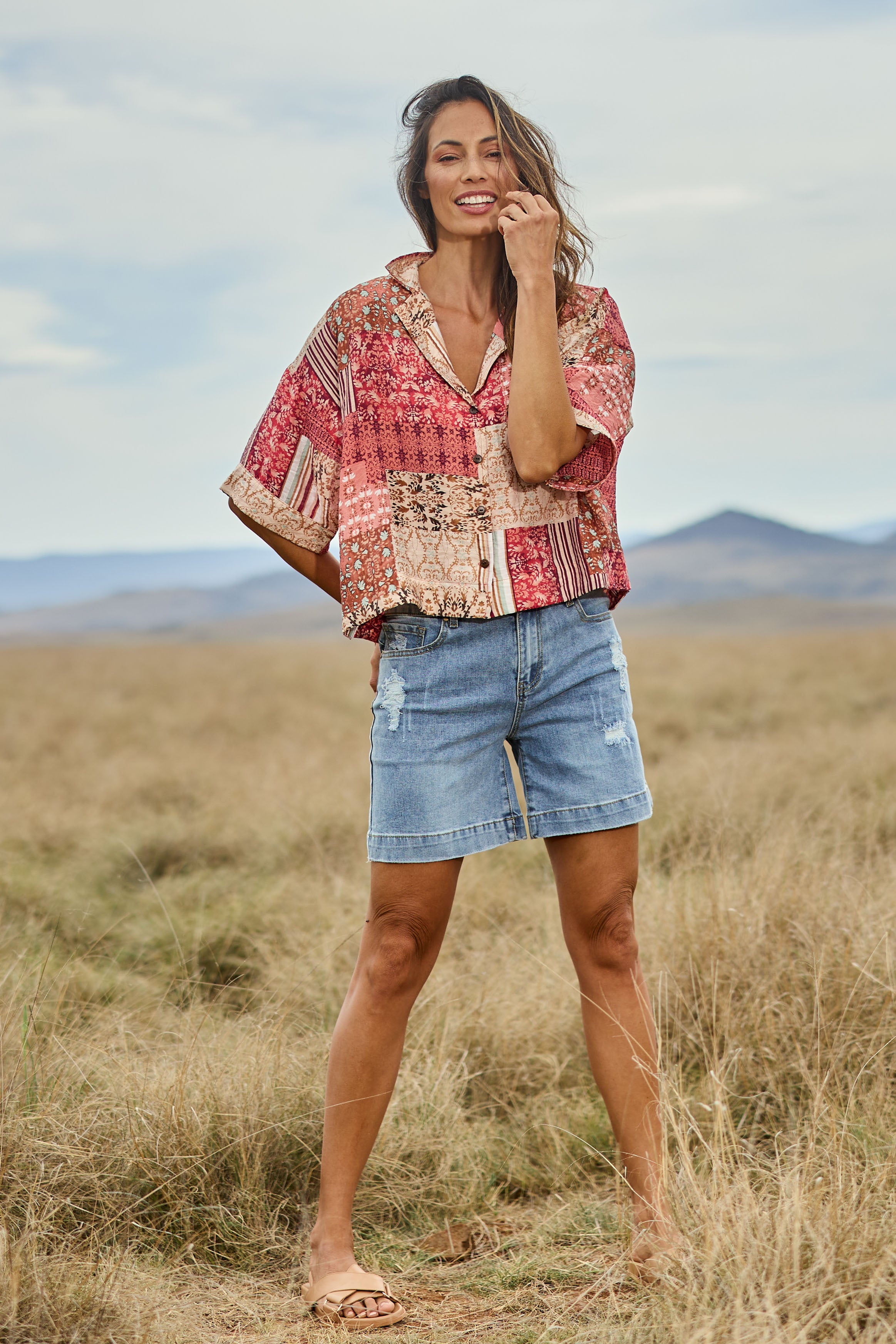 Model Amanda wearing size 10 of the Happy Daze Shirt in colour Patch (Pink), from the front, showing the whole outfit