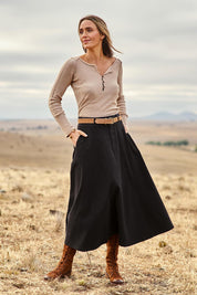 Model Tegan wearing size 10 of the Sparking Joy Denim Panelled Skirt in colour Black (Black), from the front, showing the whole outfit