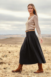 Model Tegan wearing size 10 of the Sparking Joy Denim Panelled Skirt in colour Black (Black), from the front, showing the whole outfit