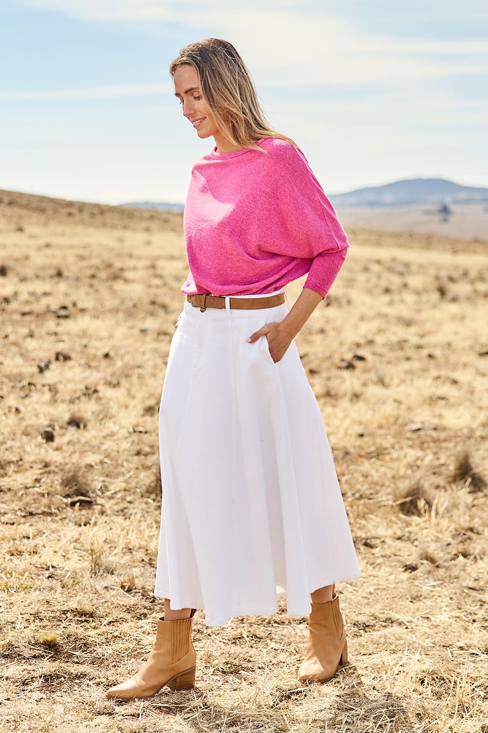 Model Tegan wearing size 10 of the Sparking Joy Denim Panelled Skirt in colour White (White), from the front, showing the whole outfit