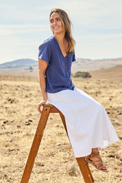 Model Tegan wearing size 10 of the Sparking Joy Denim Panelled Skirt in colour White (White), from the front, showing the whole outfit
