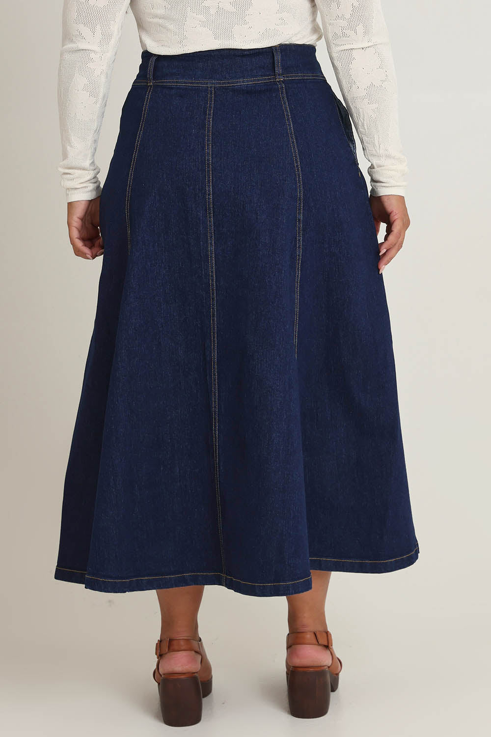 Model Ashleigh wearing size 16 of the Sparking Joy Denim Panelled Skirt in colour Denim (Blue), from the back