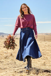 Model Tegan wearing size 10 of the Sparking Joy Denim Panelled Skirt in colour Denim (Blue), from the front, showing the whole outfit