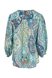 Product shot of the Easy On Me Blouse in colour Bluefolk (Blue), from the back