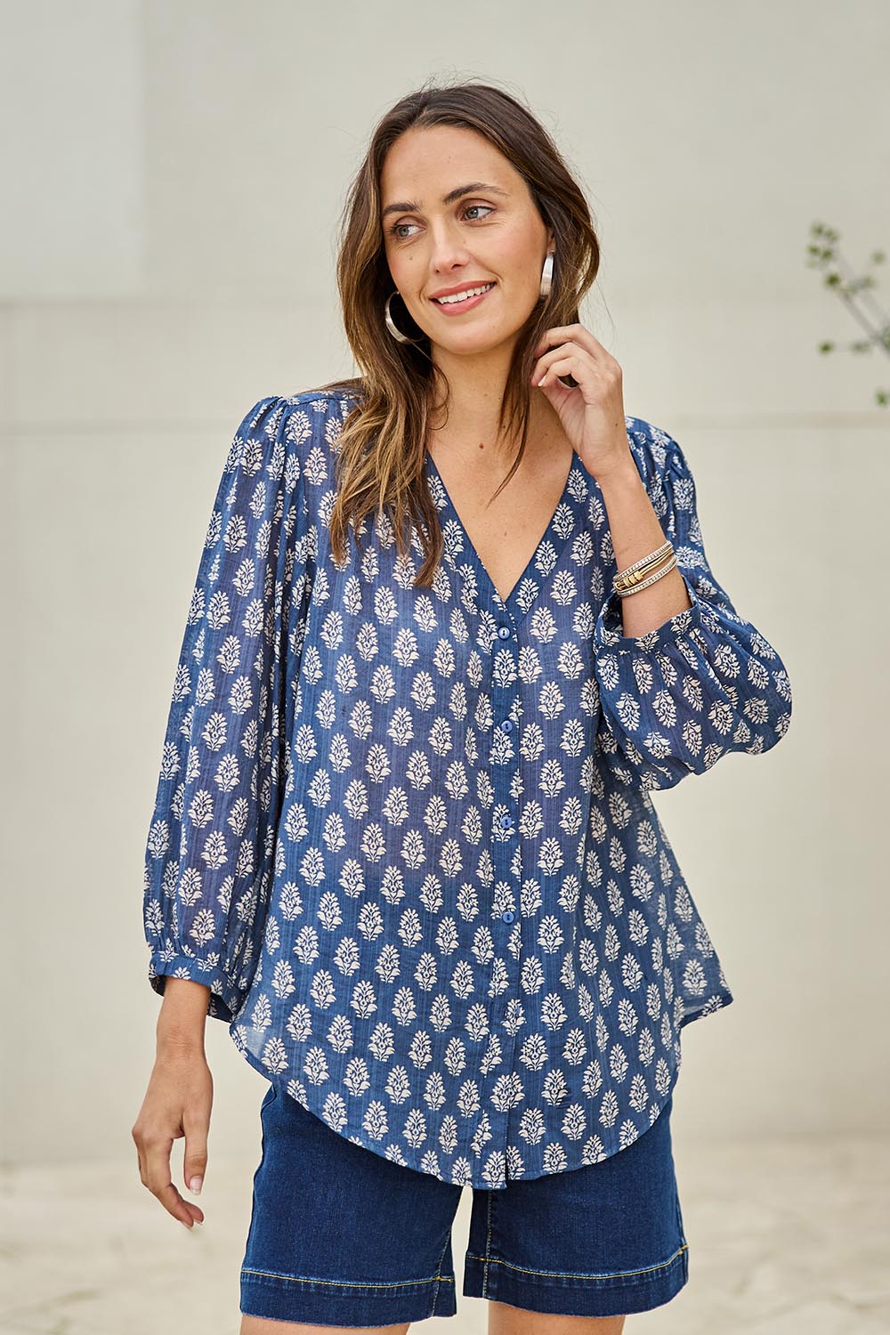 Model Tegand wearing size 10 of the Easy On Me Blouse - Denimfleur in colour Denimfleur, in a cropped view
