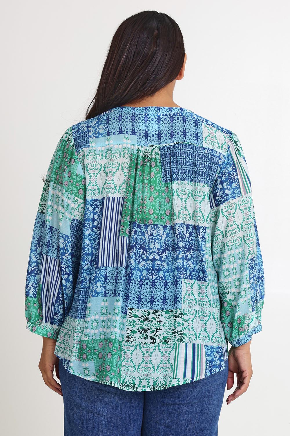 Model Ashleigh wearing size 16 of the Easy On Me Blouse in colour Green (Green), from the back
