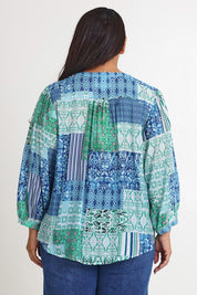 Model Ashleigh wearing size 16 of the Easy On Me Blouse in colour Green (Green), from the back