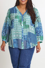 Model Ashleigh wearing size 16 of the Easy On Me Blouse in colour Green (Green), from the front, cropped image