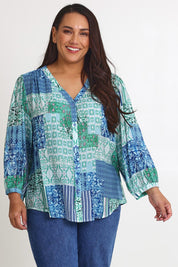 Model Ashleigh wearing size 16 of the Easy On Me Blouse in colour Green (Green), from the front, cropped image