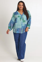 Model Ashleigh wearing size 16 of the Easy On Me Blouse in colour Green (Green), from the front, showing the whole outfit