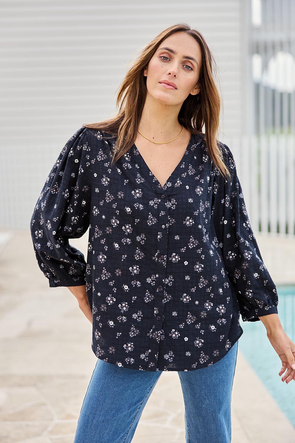 Model Tegand wearing size 10 of the Easy On Me Blouse – Navyfleur in colour Navyfleur, in a cropped view