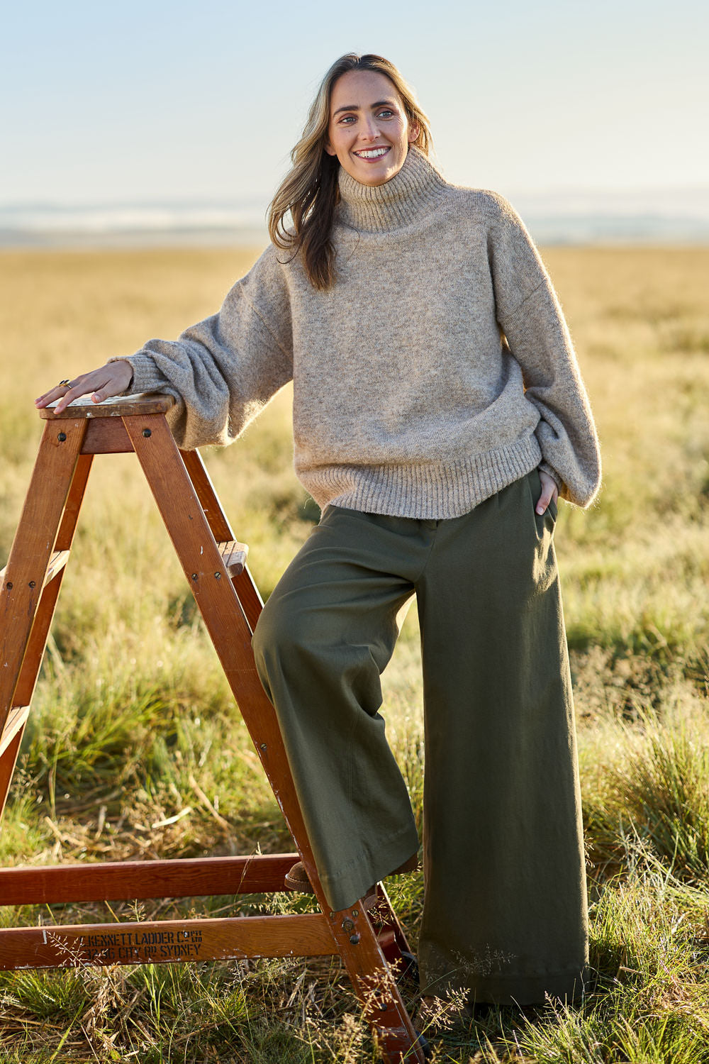 Model Tegan wearing size S of the Lovely Day Billow Sleeve Wool Blend Jumper in colour Natural, from the front, showing the whole outfit