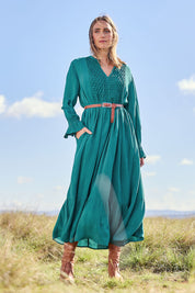 Model Tegan wearing size 10 of the Meadow Meander Smocked Dress in colour Jade (Green), from the front, showing the whole outfit