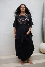 Model Tahnee wearing size 10 of the Eternal Grace Layered Dress in colour Black (Black), from the front, showing the whole outfit