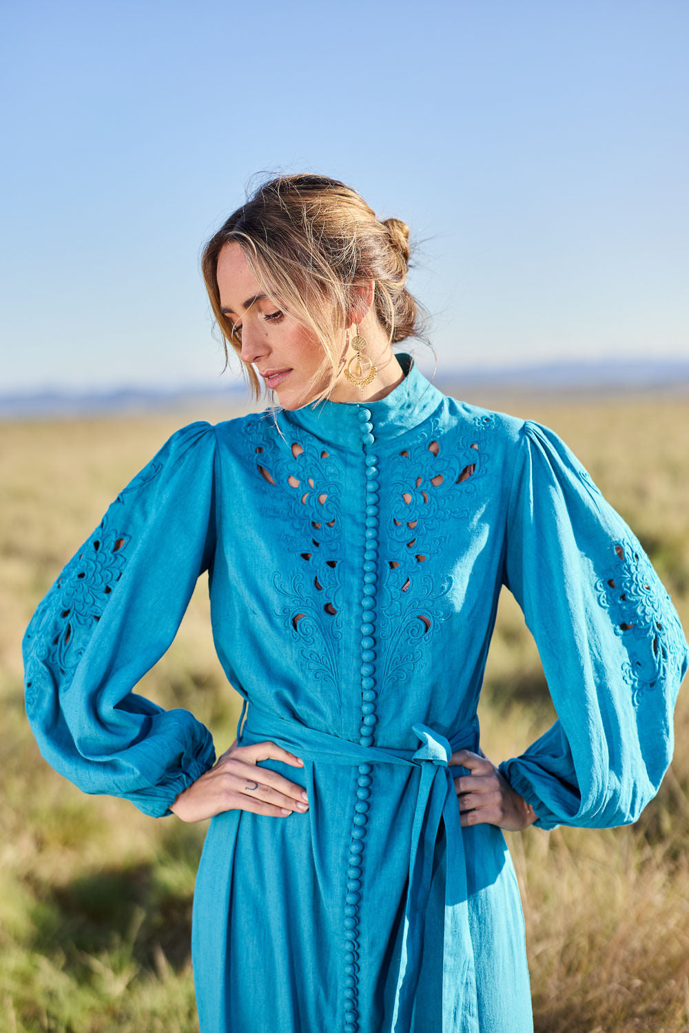 Model Tegan wearing size 10 of the Youre A Gem Button Detail Cotton Dress in colour Jade (Blue), from the front, showing the whole outfit