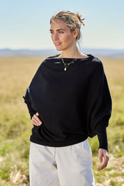 Model Naomi wearing size S of the Snuggle Up True Knit Jumper in colour Black (Black), from the front, showing the whole outfit