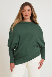 Model Chanel wearing size XL of the Snuggle Up True Knit Jumper in colour Pine (Green), from the front, cropped image