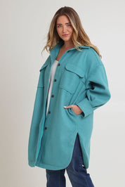 Model Chanel wearing size 14 of the Through The Trees Jacket in colour Teal (Blue), from the front, cropped image