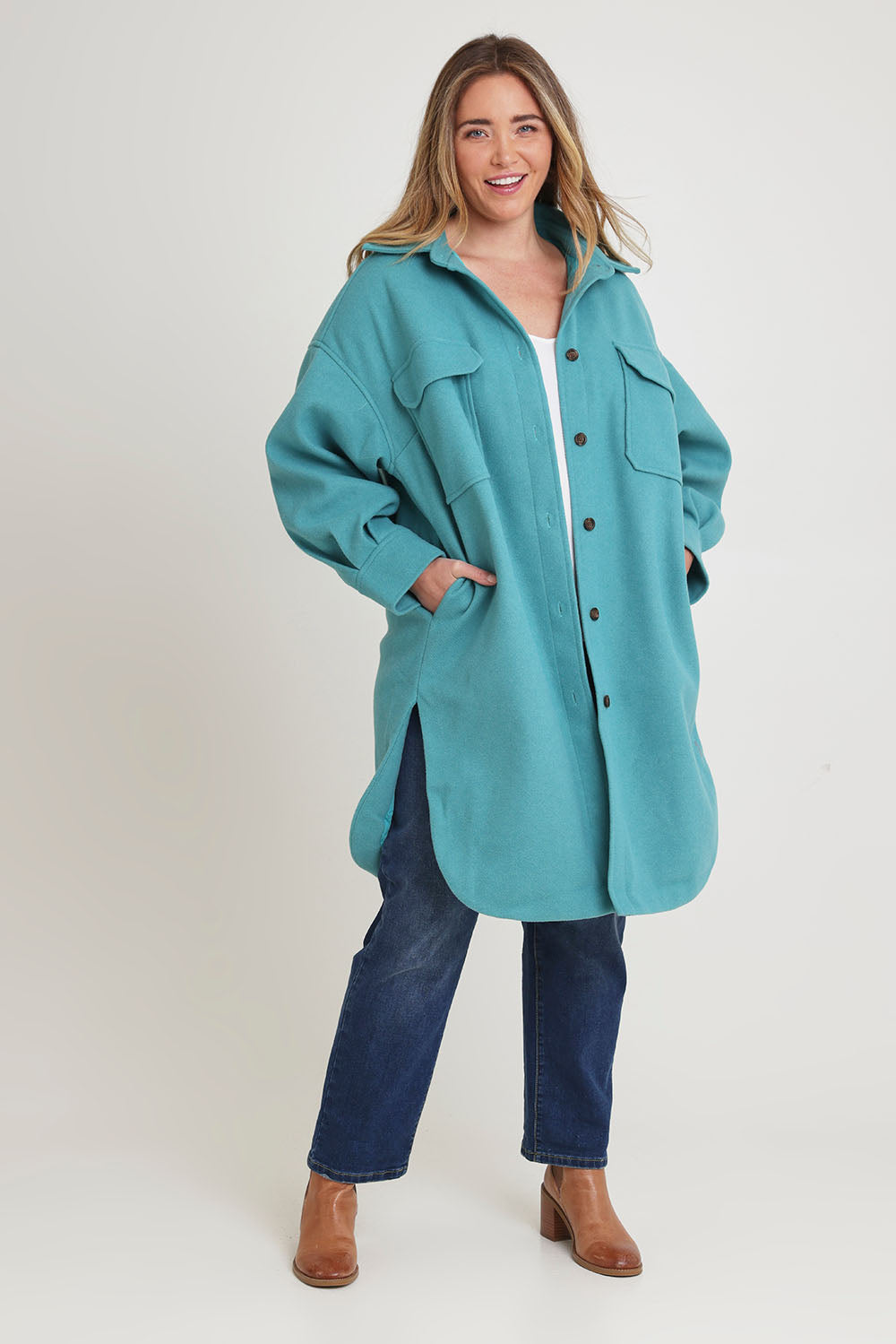 Model Chanel wearing size 16 of the Through The Trees Jacket in colour Teal (Blue), from the front, showing the whole outfit
