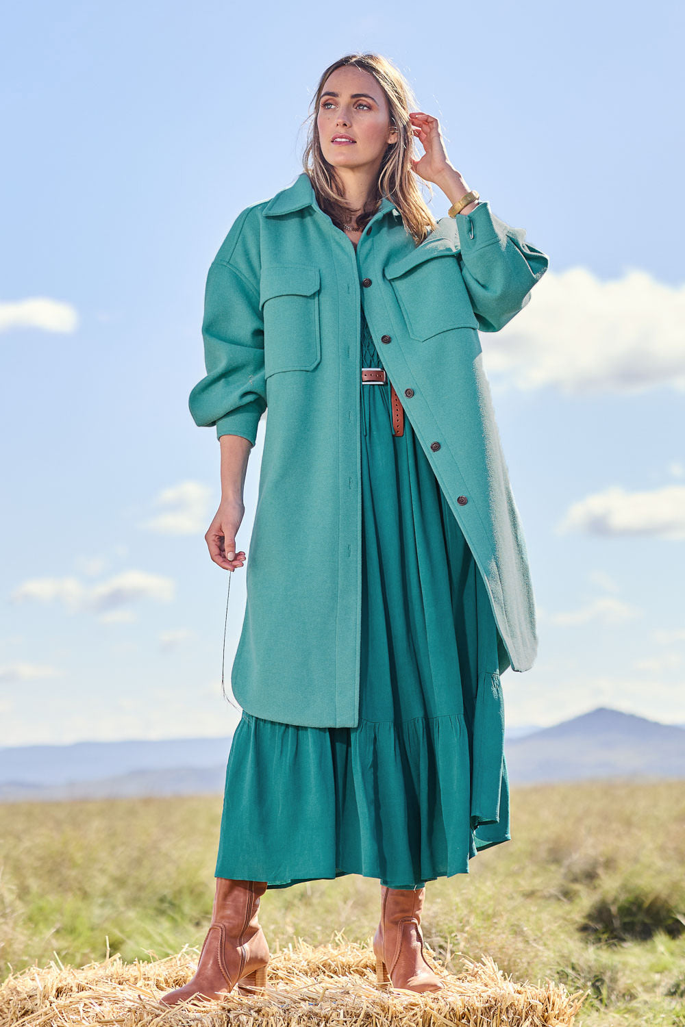 Model Tegan wearing size 10 of the Through The Trees Jacket in colour Teal (Blue), from the front, showing the whole outfit
