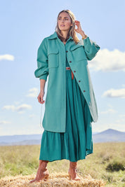 Model Tegan wearing size 10 of the Through The Trees Jacket in colour Teal (Blue), from the front, showing the whole outfit