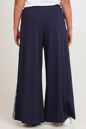 Model Chanel wearing size 16 of the Follow My Lead Side Stripe Pants in colour Navy (Blue), from the back