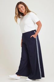 Model Chanel wearing size 16 of the Follow My Lead Side Stripe Pants in colour Navy (Blue), from the front, showing the whole outfit