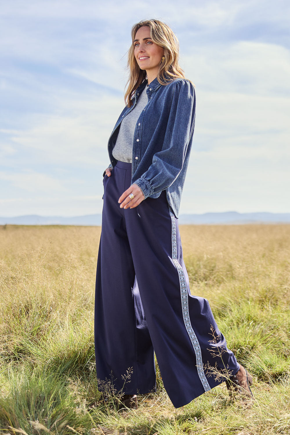 Model Tegan wearing size 10 of the Follow My Lead Side Stripe Pants in colour Navy (Blue), from the front, showing the whole outfit
