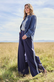 Model Tegan wearing size 10 of the Follow My Lead Side Stripe Pants in colour Navy (Blue), from the front, showing the whole outfit