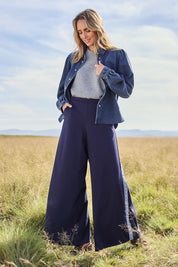 Model Tegan wearing size 10 of the Follow My Lead Side Stripe Pants in colour Navy (Blue), from the front, showing the whole outfit