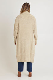 Model Chanel wearing size XL of the Sunday Walks Longline Cardi in colour Sand, from the back