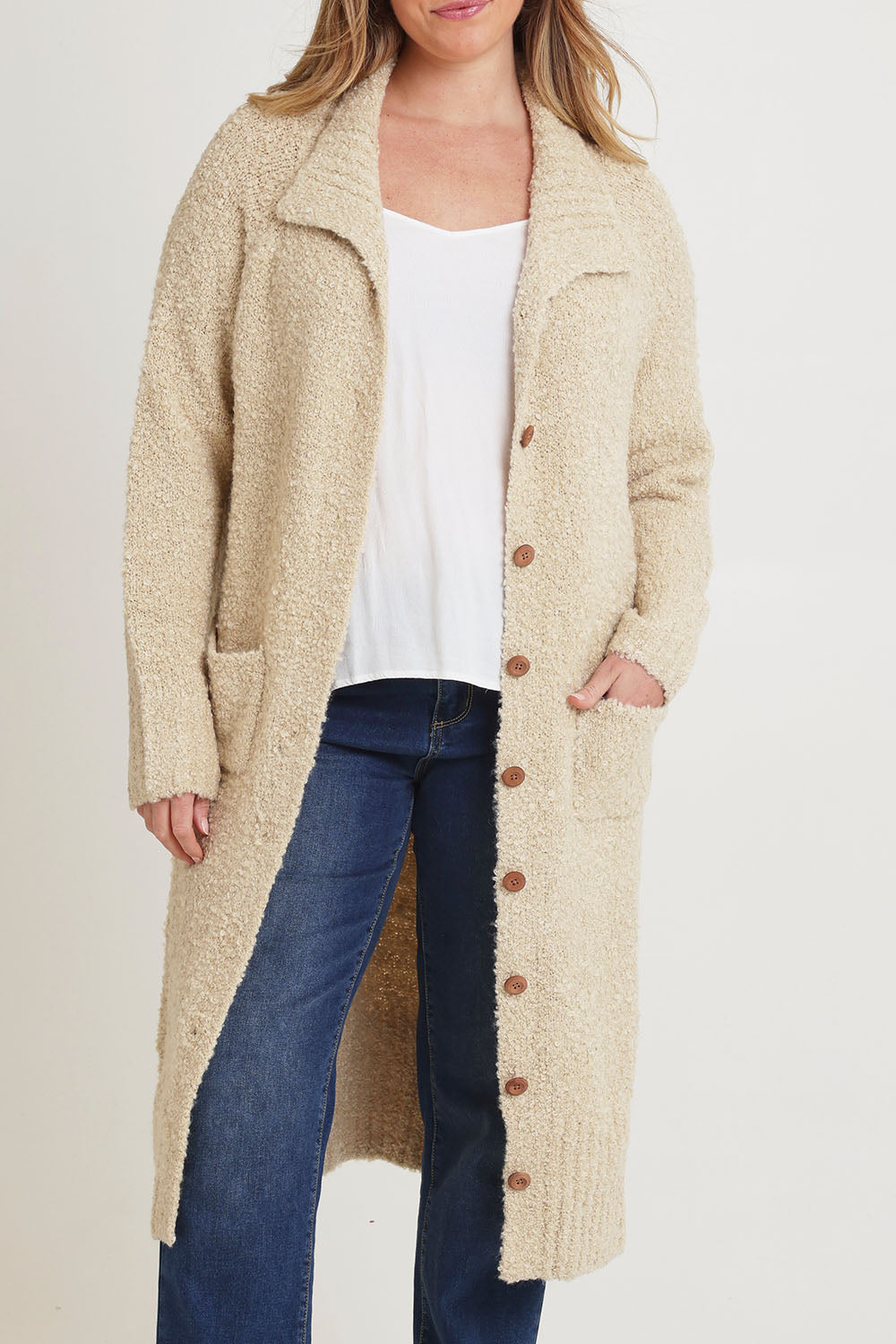 Model Chanel wearing size XL of the Sunday Walks Longline Cardi in colour Sand, from the front, cropped image