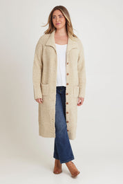 Model Chanel wearing size XL of the Sunday Walks Longline Cardi in colour Sand, from the front, showing the whole outfit