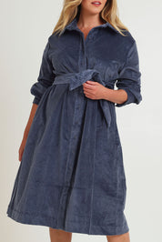 Model Chanel wearing size 16 of the High Impact Cord Dress in colour Blue (Blue), from the front, cropped image