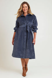 Model Chanel wearing size 16 of the High Impact Cord Dress in colour Blue (Blue), from the front, showing the whole outfit