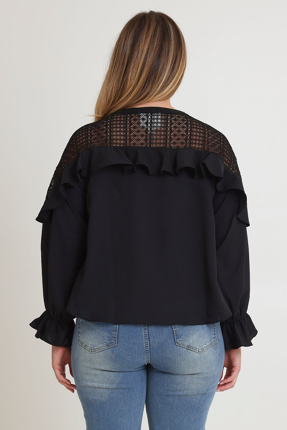 Model Chanel wearing size 16 of the Good Feels Lace Detail Blouse in colour Black (Black), from the back