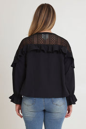 Model Chanel wearing size 16 of the Good Feels Lace Detail Blouse in colour Black (Black), from the back