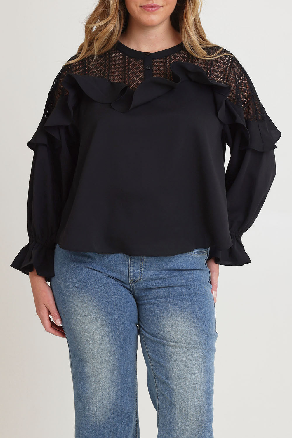 Model Chanel wearing size 16 of the Good Feels Lace Detail Blouse in colour Black (Black), from the front, cropped image