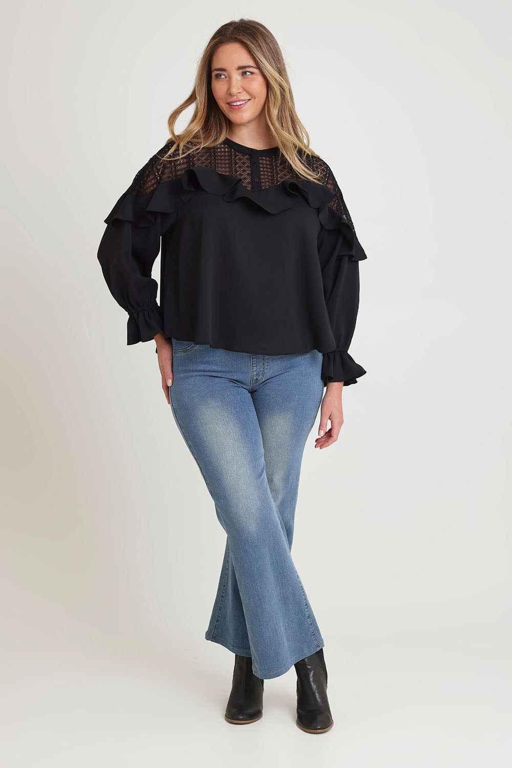Model Chanel wearing size 16 of the Good Feels Lace Detail Blouse in colour Black (Black), from the front, showing the whole outfit