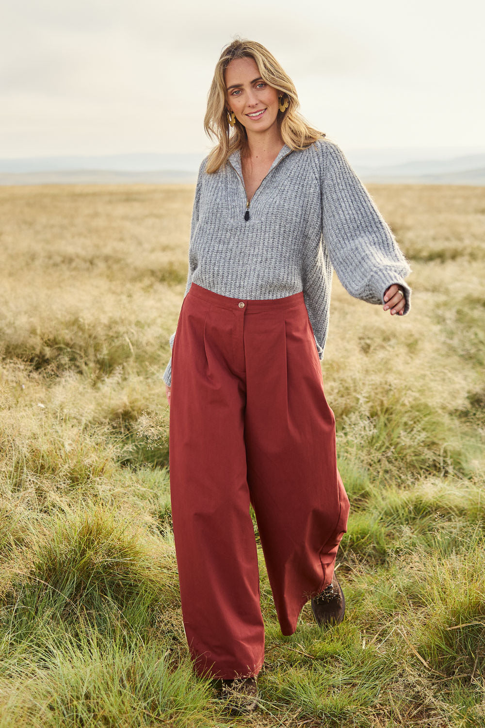 Model Tegan wearing size 10 of the Take The High Road Cotton Wide Leg Pants in colour Bordeaux (Red), from the front, showing the whole outfit