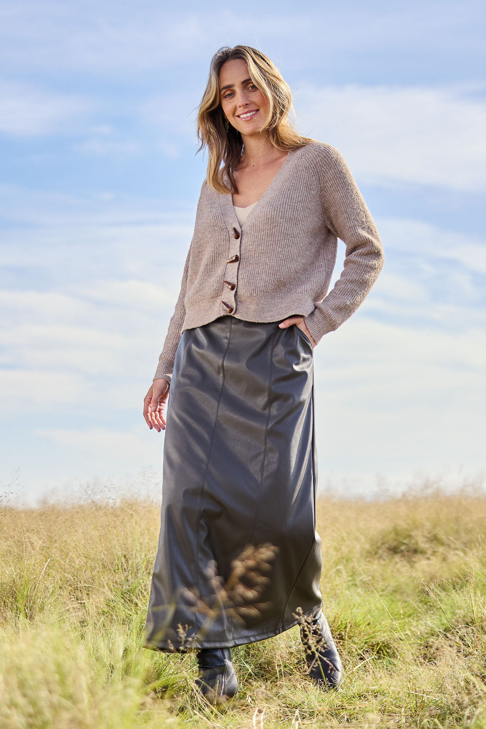 Model Tegan wearing size 10 of the Easy Elegance Vegan Leather Maxi Skirt in colour Olive (Green), from the front, showing the whole outfit