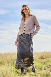 Model Tegan wearing size 10 of the Easy Elegance Vegan Leather Maxi Skirt in colour Olive (Green), from the front, showing the whole outfit
