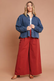 Model Chanel wearing size 16 of the Denim Daze Billow Sleeve Shirt in colour Denim (Blue), from the front, showing the whole outfit