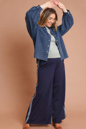 Model Chanel wearing size 16 of the Denim Daze Billow Sleeve Shirt in colour Denim (Blue), from the front, showing the whole outfit