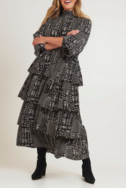 Model Chanel wearing size 16 of the Wonderland Tiered Dress in colour Blackwhite (Black), from the front, cropped image