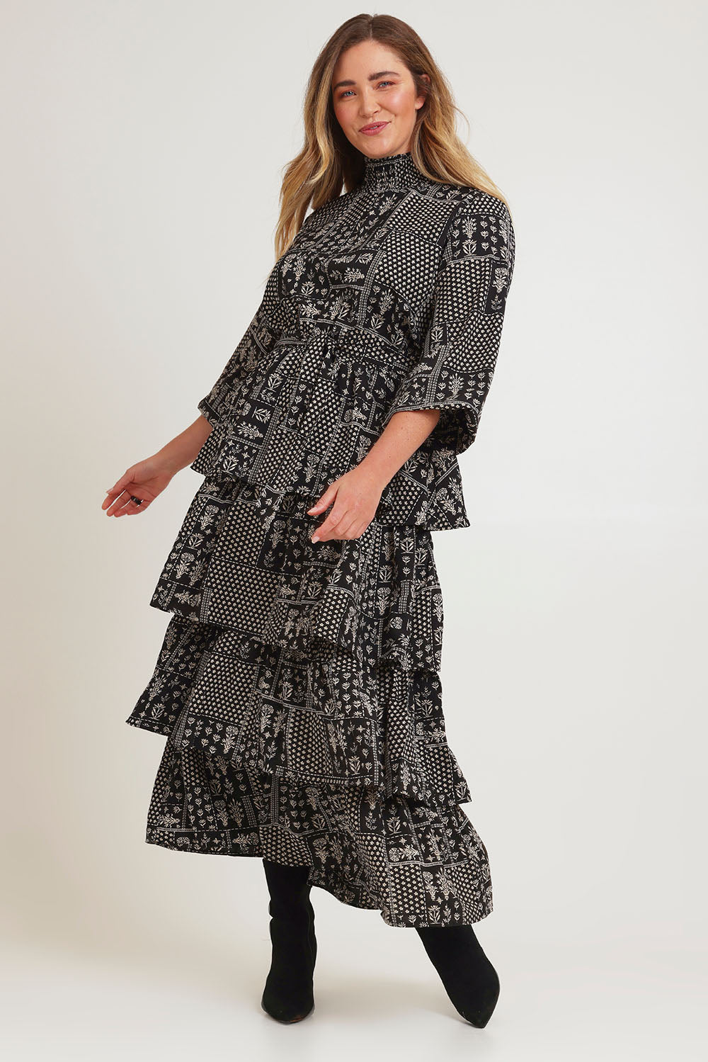 Model Chanel wearing size 16 of the Wonderland Tiered Dress in colour Blackwhite (Black), from the front, showing the whole outfit