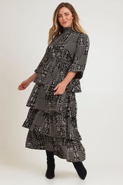 Model Chanel wearing size 16 of the Wonderland Tiered Dress in colour Blackwhite (Black), from the front, showing the whole outfit